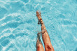Leinwandbild Motiv beautiful woman legs splashing in the pool