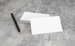 © bubak282 - 3D render of Blank white Business card presentation of Corporate id with black pen on concrete desk.