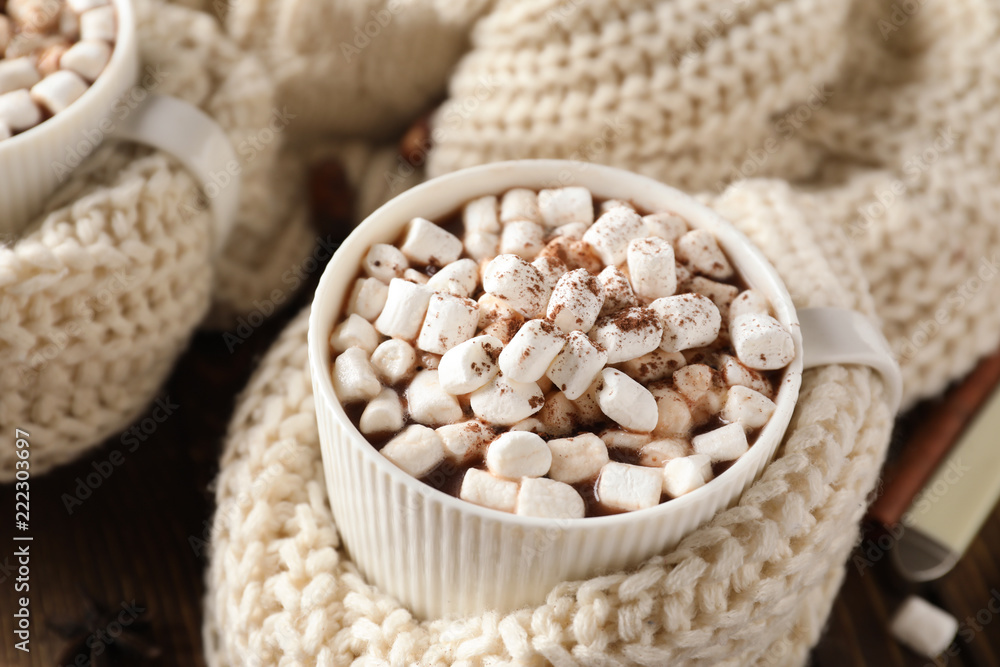 Cup of delicious cocoa with marshmallows on table, closeup