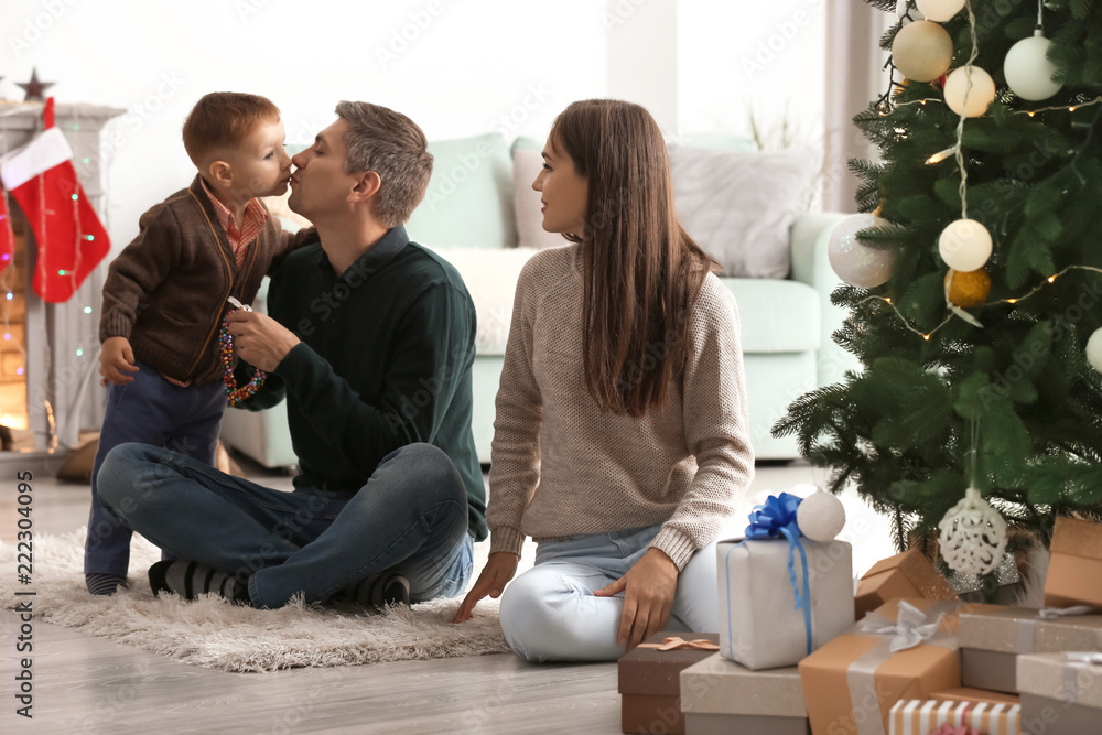 Happy family near Christmas tree at home
