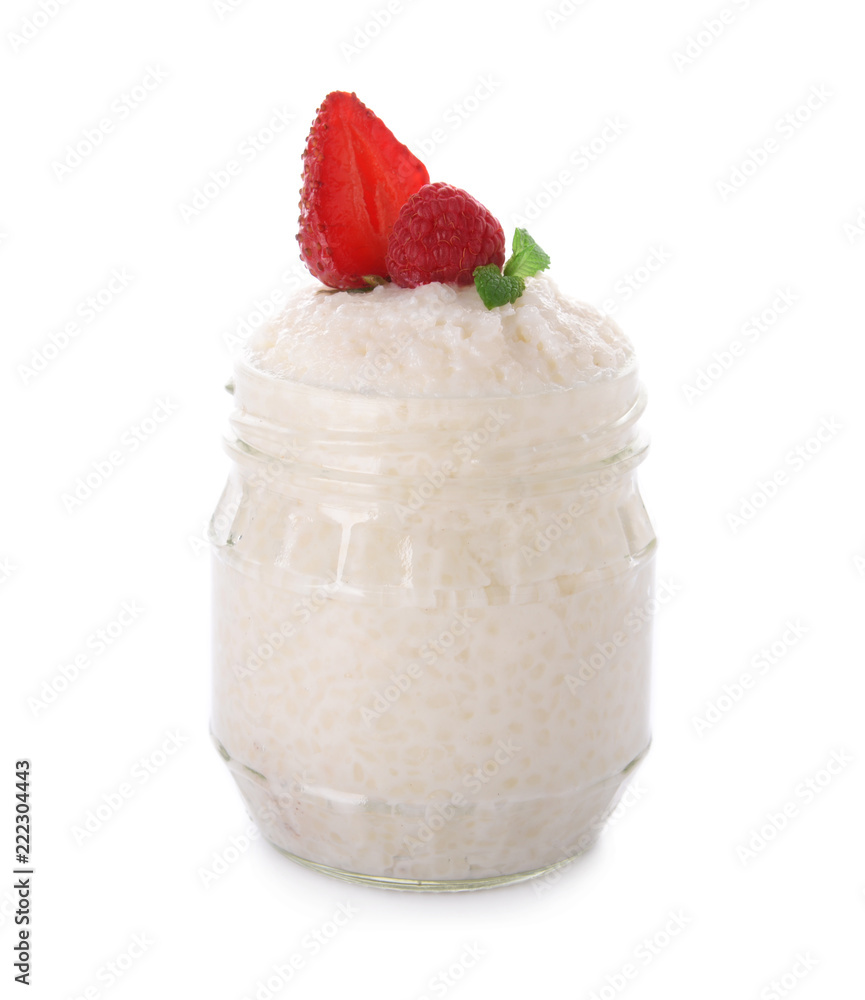 Delicious rice pudding with berries in jar on white background