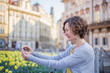 © vitaprague - A tourist woman is walking around Prague on a sunny day.