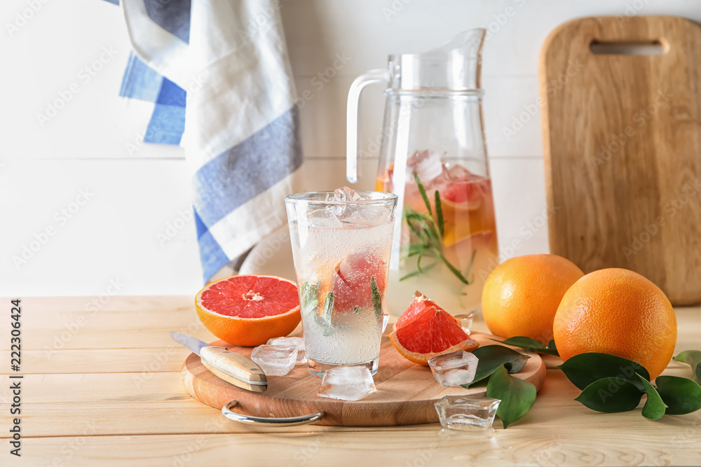 Composition with refreshing grapefruit lemonade on wooden table