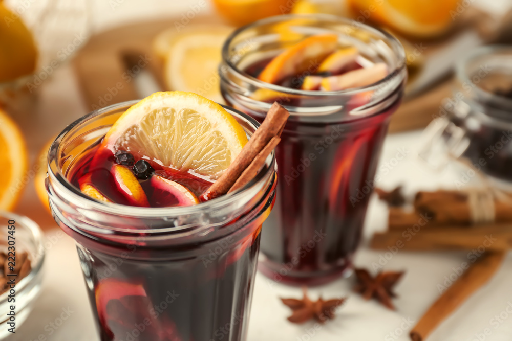 Jars of delicious mulled wine on light table