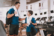 © VadimGuzhva - Young Father and Son near Treadmills in Modern Gym
