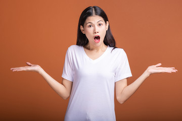 Wall Mural - Surprise woman over orange background.