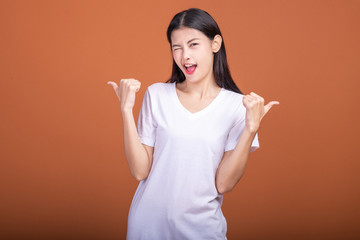 Wall Mural - Winning woman isolated over orange background.