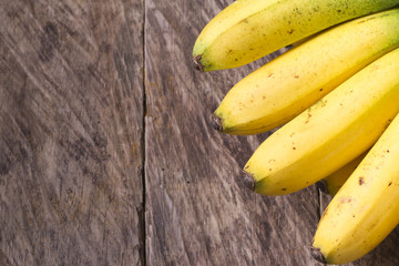 Wall Mural - banana fruit on the wooden table (Musa × paradisiaca)