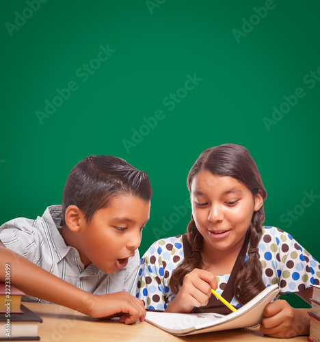 Blank Chalk Board Behind Hispanic Boy and Girl Having Fun Studying Together