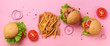 Fast food banner. Juicy meat burgers with beef, tomato, cheese, onion, cucumber and lettuce on pink background. Top view, copy space. Take away meal. Unhealthy diet concept