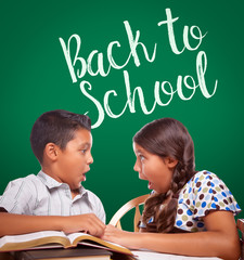 Wall Mural - Back To School Written On Chalk Board Behind Hispanic Boy and Girl Having Fun Studying Together