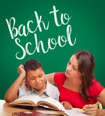 Wall Mural - Back To School Written On Chalk Board Behind Hispanic Young Boy and Famale Adult Studying