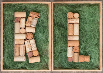 Wall Mural - Alphabet letter K and  L made of  wine corks on green background in wooden box. ABC set