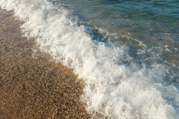 Wave of blue ocean on beach close up Summer Background