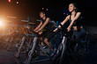 Young People - Group of women and men - Doing sport biking in the gym for fitness