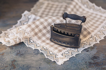 Hot, vintage old iron with coal on linen fabric, selective focus