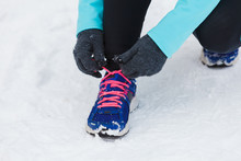 Tying Sport Shoes In Snow