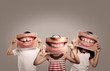 © xavier gallego morel - three children holding a picture of a mouth smiling