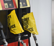 Empty Pumps Are Marked With Yellow Bags Reading "sorry Out Of Service" As Gas Stations Run Out Of Supply.