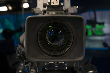 Sticker - Television Film Camera with focus on the rim of the lens. On Air Broadcast sign in the background.