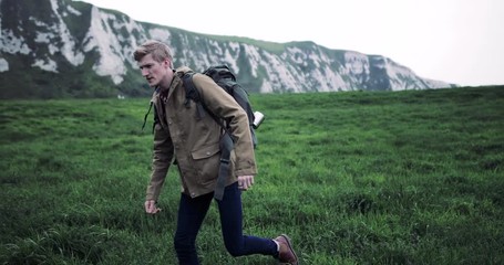 millennial walking on a rural path looking at landscape
