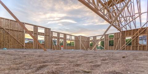 Wall Mural - Wooden beams in sand area in building wide pano