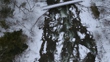 Aerial Drone Footage Of Chittenango Falls During The Winter.  The Snow Melt On This Warm Day Resulted In The Strong Current. I Flew My Drone Over The Iconic Bridge Located Outside Of Cazenozia, New Yo