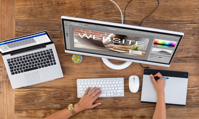 Designer Creating Website On Computer