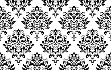 Wallpaper in the style of Baroque. Seamless vector background. White and black floral ornament. Graphic pattern for fabric, wallpaper, packaging. Ornate Damask flower ornament