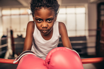close up of a boxing kid wearing boxing gloves