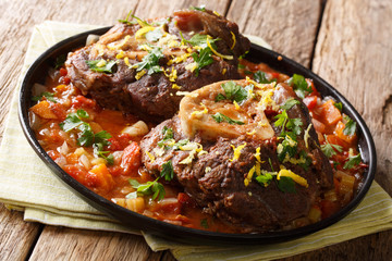 beef shank Ossobuco alla Milanese with gremolata and spicy sauce closeup. Horizontal