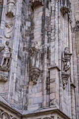 Wall Mural - Vertical: Closeup detail of the intricate artistry, sculpture, window work,spires, marbel bricks of exterior of the Duomo di Milano