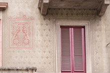 Beautiful Example Of Intricate Etching, Artwork And Pink Window Shutters Of A Milan, Italyapartment