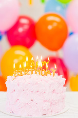 cake with burning candles in the form of the inscription 