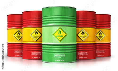 Green biofuel drum in front of red oil or gas barrels isolated on white backg...
