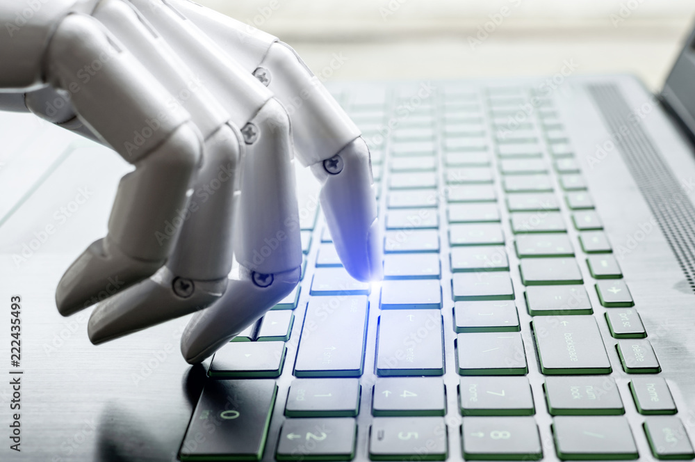 Robot hand pressing computer keyboard enter
