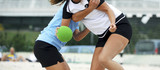 Beach handball  woman players in action on a sunny day