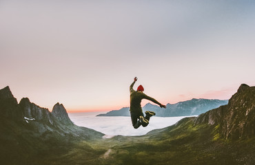 Jumping man in mountains vacations outdoor Travel Lifestyle adventure concept active success motivation and fun euphoria emotions