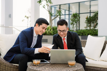 Cheerful smart businessmen discussing their project