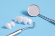 Zircon dentures samples on a blue sheet with dental tools - Ceramic veneers - lumineers