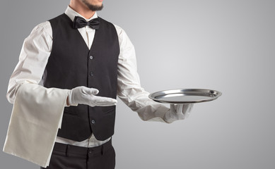 Wall Mural - Waiter serving with white gloves and steel tray in an empty space
