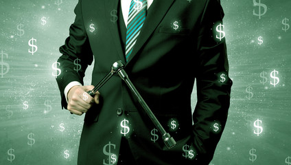 Wall Mural - Handsome businessman holding tool with dollar symbols around and with green background