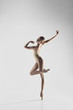 © master1305 - Young graceful female ballet dancer or classic ballerina dancing on white studio. Caucasian model on pointe shoes