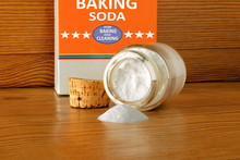 Baking Soda Or Baking Powder In Bottle Isolated In Wooden Background For Cooking Recipe Or Cleaning
