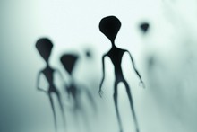 Spooky Silhouettes Of Aliens And Bright Light In Background. 3D Rendered Illustration.