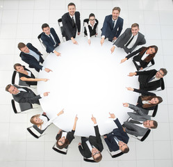 Wall Mural - business team indicates the center of the round table.