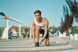 © diignat - Determined young male runner getting ready to start running