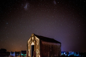 Wall Mural - Church in the foreground in starry night - Magellanic clouds.