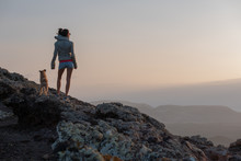 Girl On The Top Of The Volcano With Her Dog