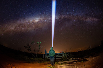 Wall Mural - Woman with cold clothes lighting the sky - Milk Way.